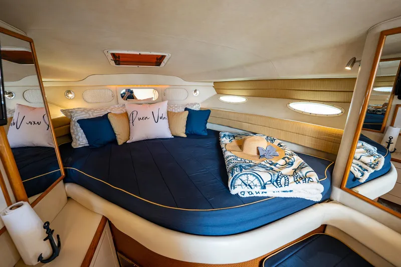 Slide: The Image of Luxurious cabin interior of 1997 Sea Ray 330 Sundancer with cozy bedding and nautical decor. - 27