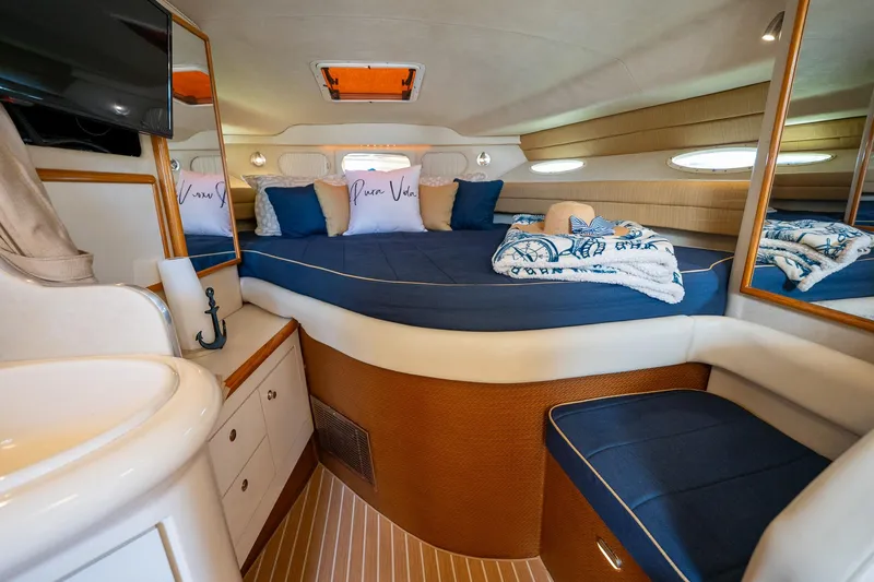 Slide: The Image of 1997 Sea Ray 330 Sundancer cabin with cozy bed, pillows, and elegant decor. - 28