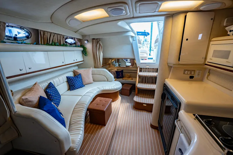 Slide: The Image of Luxurious interior of 1997 Sea Ray 330 Sundancer yacht with plush seating and kitchenette. - 31