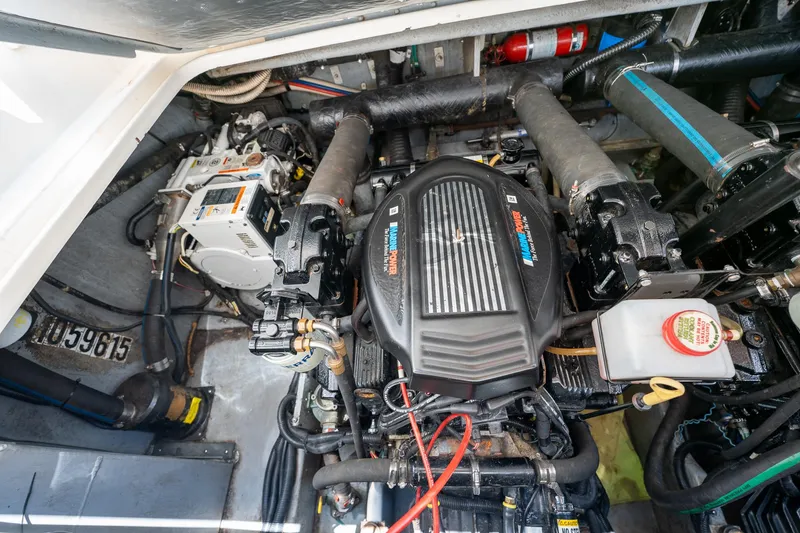 Slide: The Image of Engine compartment of a 1997 Sea Ray 330 Sundancer boat, showcasing detailed mechanical components. - 42