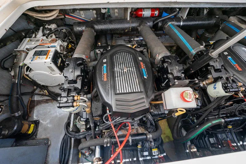 Slide: The Image of Engine compartment of a 1997 Sea Ray 330 Sundancer boat, showcasing twin engines. - 44