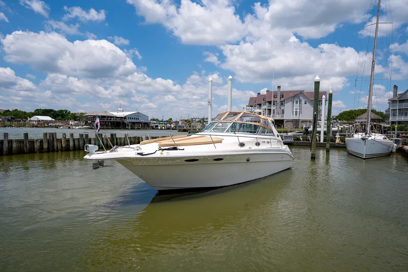 Slide: The Image of 1997 Sea Ray 330 Sundancer yacht docked in a marina under a blue sky. - 7