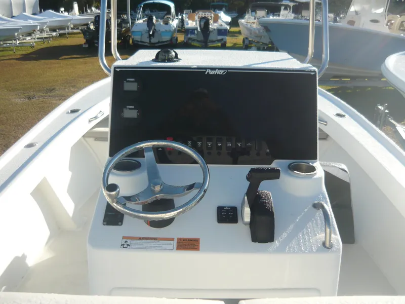 Slide: The Image of 2023 Parker 21 SE boat console with steering wheel and control panel. - 4
