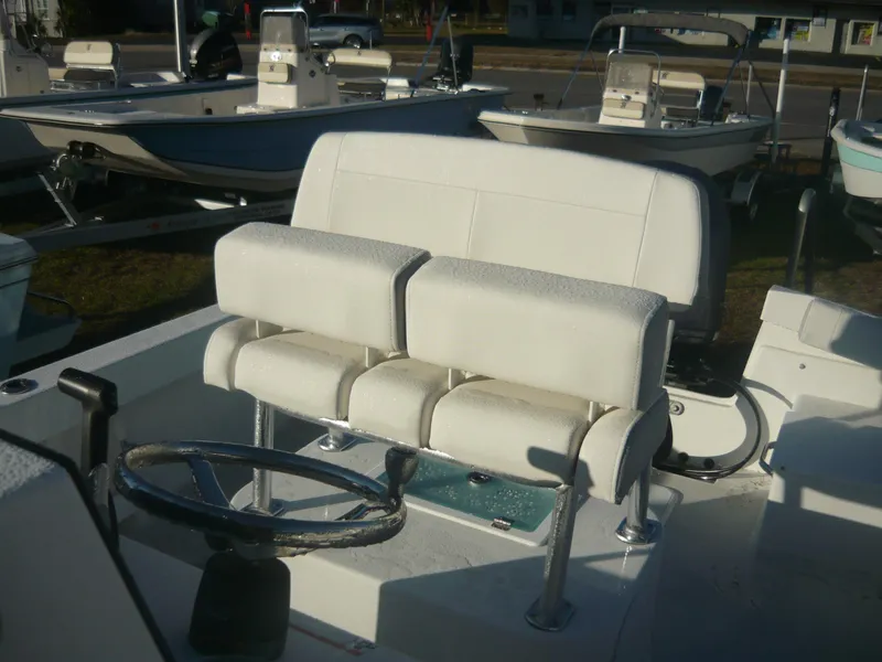 Slide: The Image of 2023 Parker 21 SE boat interior with dual white cushioned seats and steering wheel. - 5