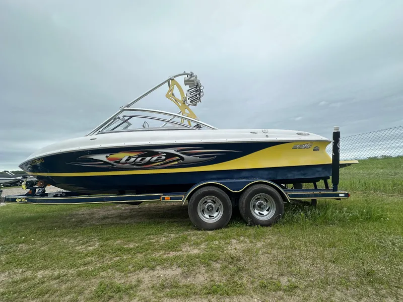 The Image of 2006 Tigé 22VE/SK boat on trailer, side view, yellow and black. - 0