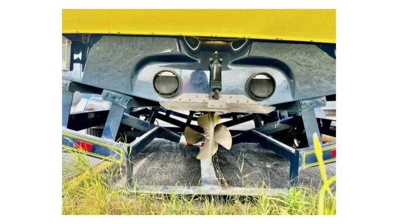 Slide: The Image of Rear view of 2006 Tigé 22VE/SK boat on trailer, showing propeller and hull. - 13