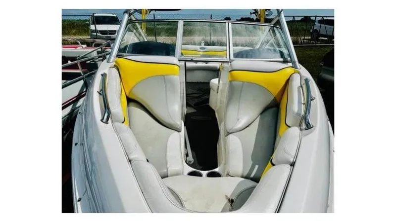 Slide: The Image of 2006 Tigé 22VE/SK boat interior with yellow and white seating. - 16