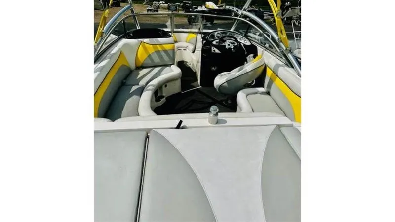 Slide: The Image of 2006 Tigé 22VE/SK boat interior with yellow and white seating. - 2