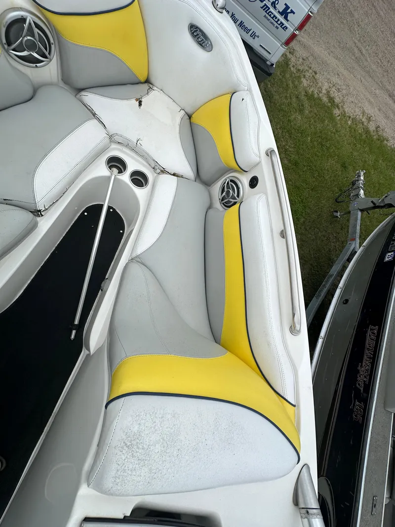 Slide: The Image of 2006 Tigé 22VE/SK boat interior with yellow and white seating. - 22
