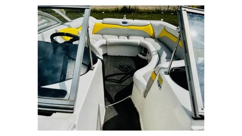 Slide: The Image of 2006 Tigé 22VE/SK boat interior with yellow and white seating. - 3