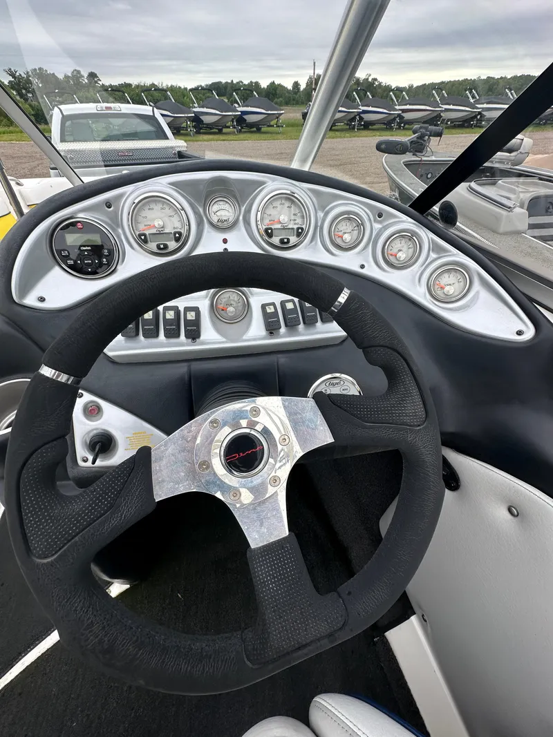 Slide: The Image of 2006 Tigé 22VE/SK boat dashboard with steering wheel and gauges. - 30