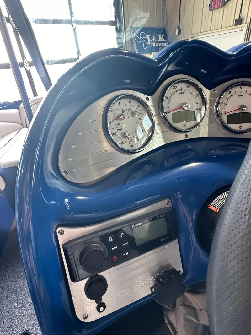 Slide: The Image of 2016 Sanger V215 boat dashboard with gauges and controls. - 10