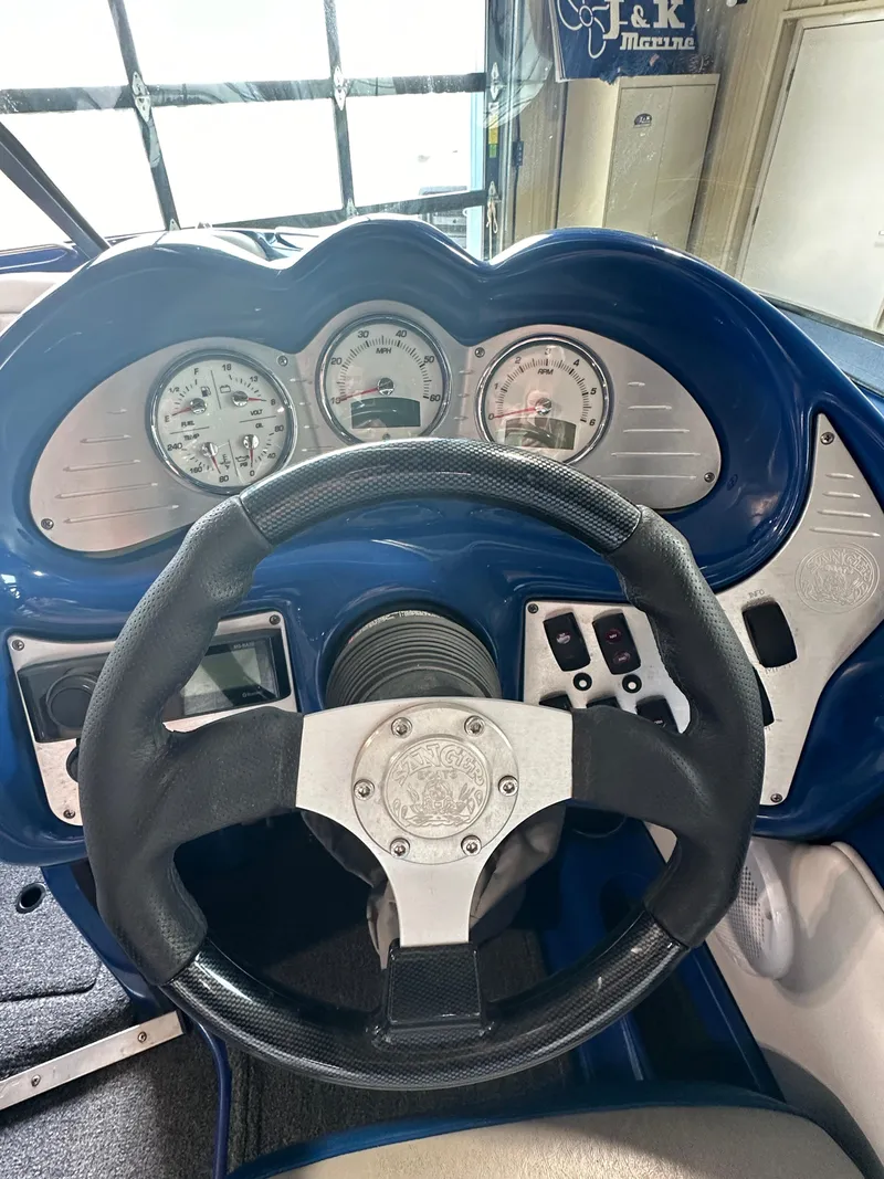 Slide: The Image of 2016 Sanger V215 boat dashboard with steering wheel and gauges. - 11