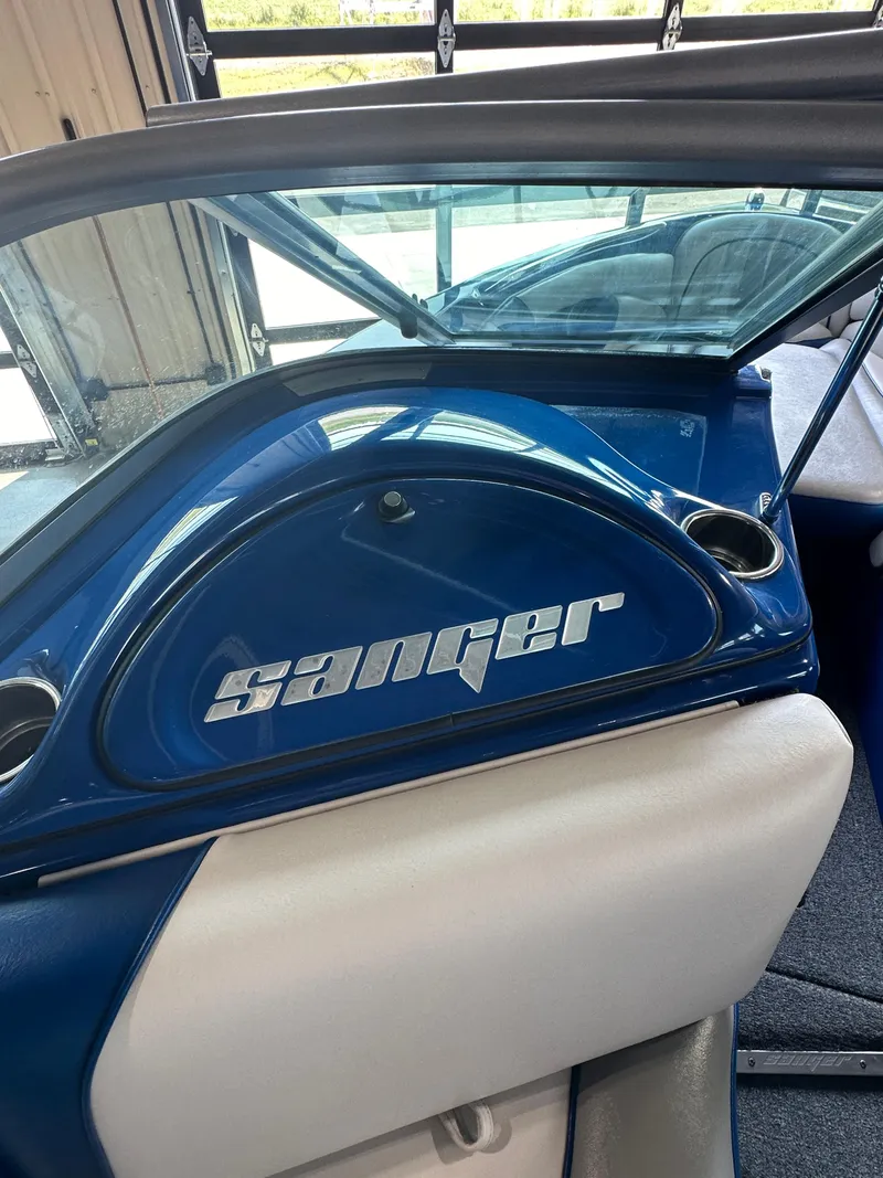 Slide: The Image of 2016 Sanger V215 boat interior with blue and white seating. - 15