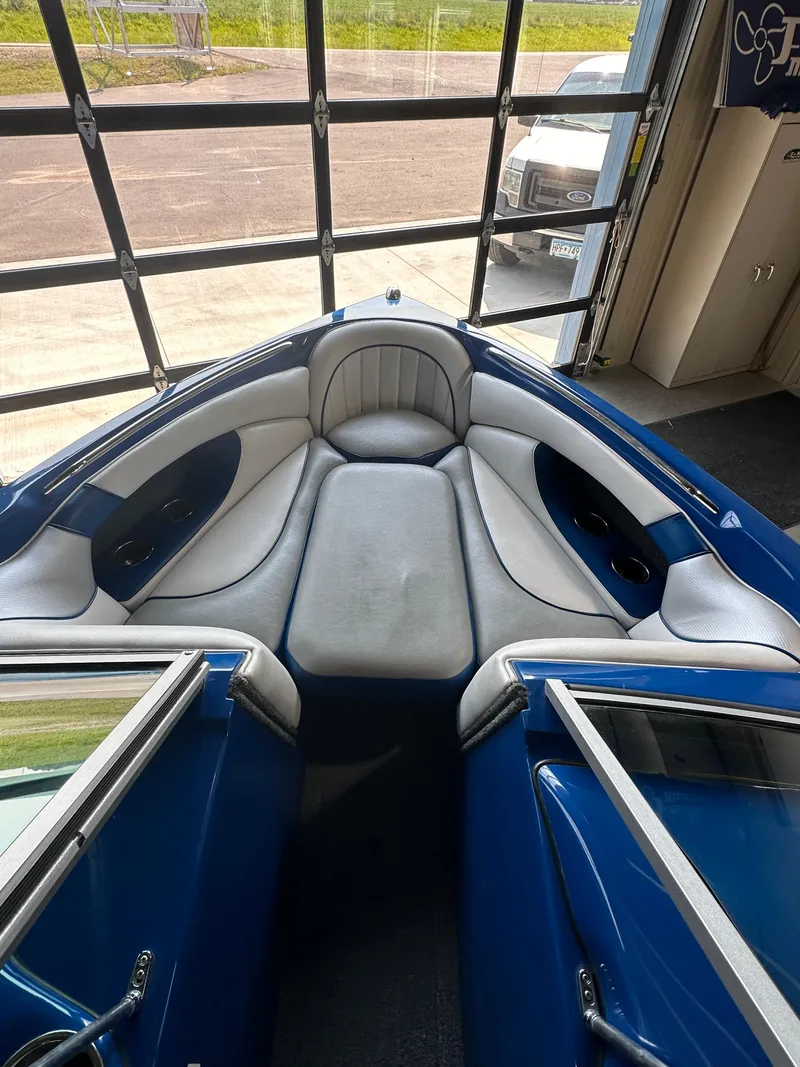 Slide: The Image of 2016 Sanger V215 boat interior with blue and gray seating. - 17