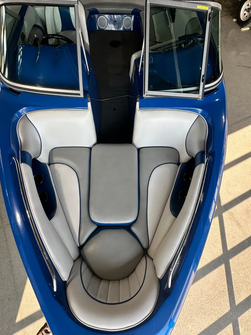 Slide: The Image of 2016 Sanger V215 boat with blue and white interior seating. - 18