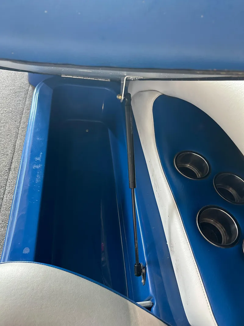 Slide: The Image of 2016 Sanger V215 boat interior storage compartment and cup holders. - 3
