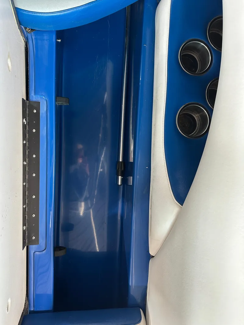 Slide: The Image of 2016 Sanger V215 boat interior storage compartment with cup holders. - 4