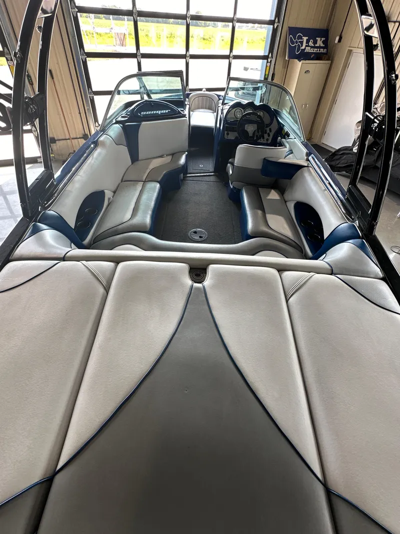 Slide: The Image of 2016 Sanger V215 boat interior with spacious seating and modern dashboard. - 5