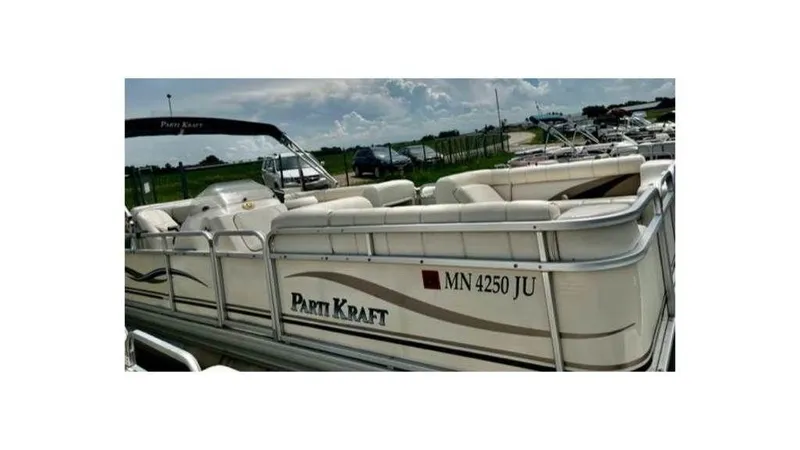 Slide: The Image of 2004 Godfrey Particraft 220SC pontoon boat, side view, docked, with seating and canopy. - 5