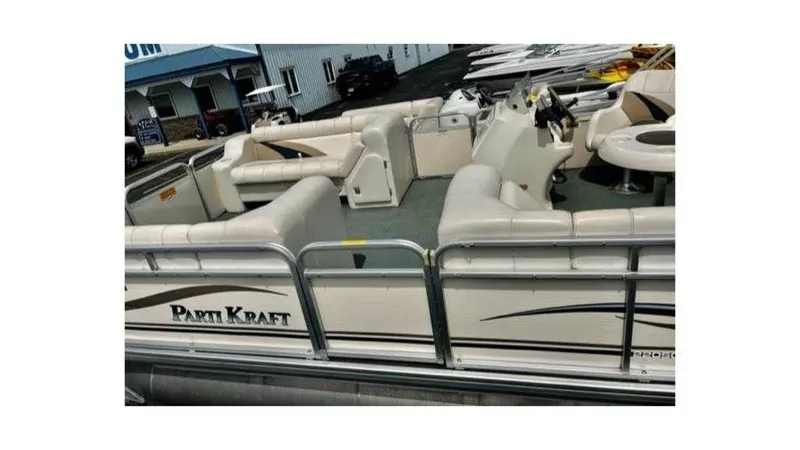 Slide: The Image of 2004 Godfrey PartiKraft 220SC pontoon boat with beige seating and steering console. - 6