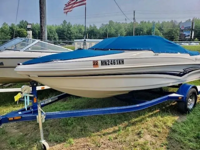 The Image of 2008 Larson 180 Sport boat on trailer with blue cover. - 0