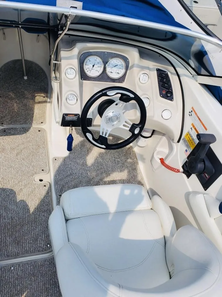 Slide: The Image of 2008 Larson 180 Sport boat cockpit with steering wheel and instrument panel. - 8