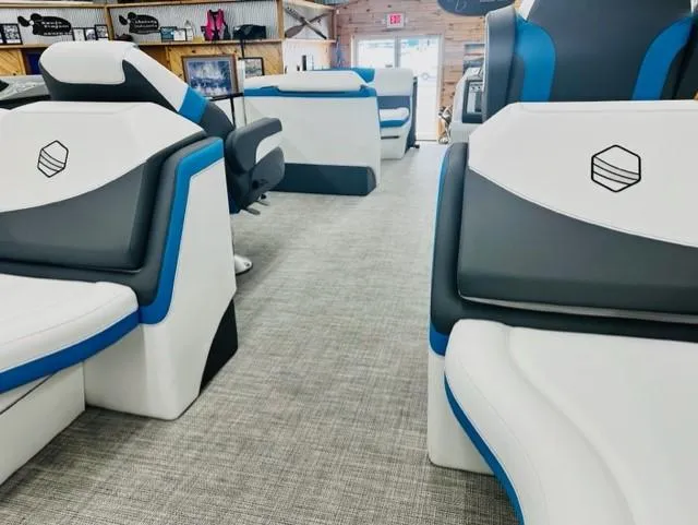 Slide: The Image of Interior of 2023 South Bay 523RS ARCH3.0 pontoon boat with white and blue seating. - 10