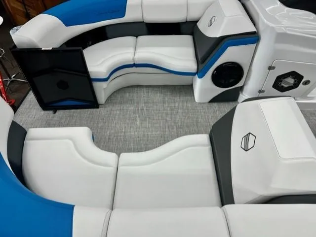 Slide: The Image of 2023 South Bay 523RS ARCH3.0 boat interior with white and blue seating. - 3