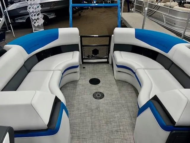 Slide: The Image of 2023 South Bay 523RS ARCH3.0 pontoon boat interior with white and blue seating. - 6