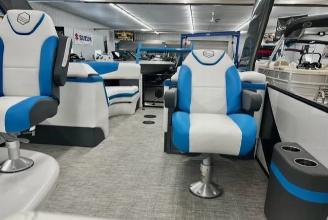 Slide: The Image of 2023 South Bay 523RS ARCH3.0 pontoon boat interior with blue and white seating. - 9