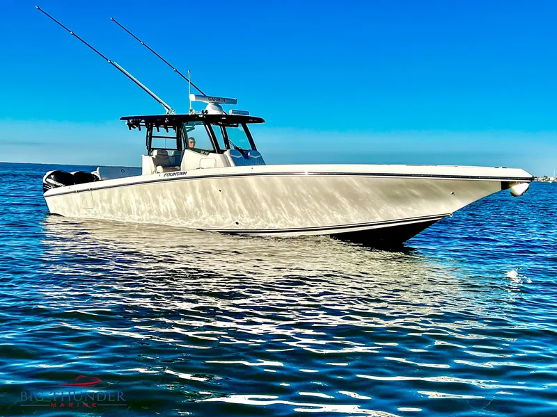The Image of 2023 Fountain 38 TE boat on calm blue water under clear sky. - 0