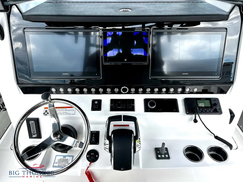 Slide: The Image of 2023 Fountain 38 TE boat dashboard with dual Garmin displays and steering wheel. - 20