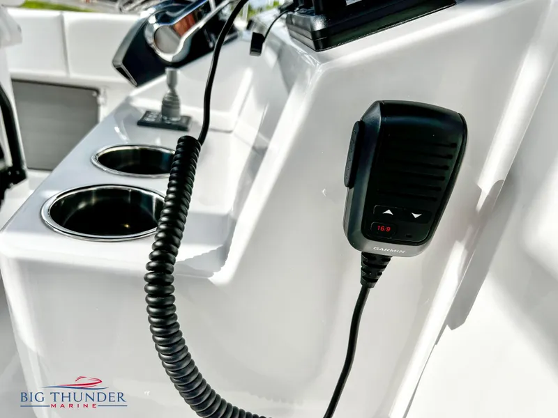 Slide: The Image of Close-up of the 2023 Fountain 38 TE boat's control panel with a microphone. - 26
