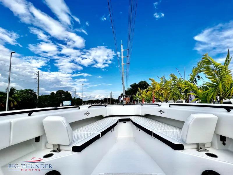 Slide: The Image of 2023 Fountain 38 TE boat interior with white seating, blue sky background. - 41