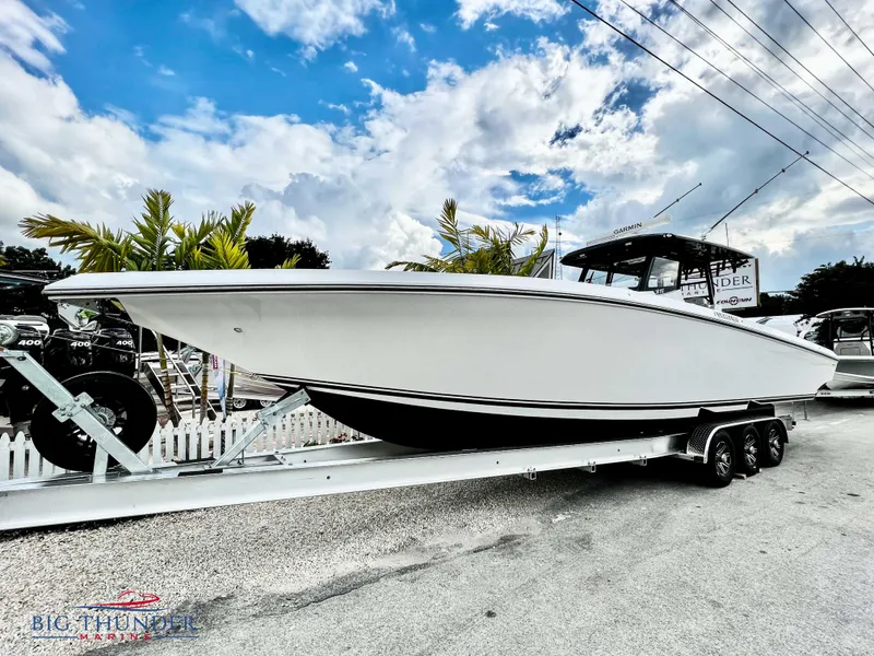Slide: The Image of 2023 Fountain 38 TE boat on a trailer under a partly cloudy sky. - 7