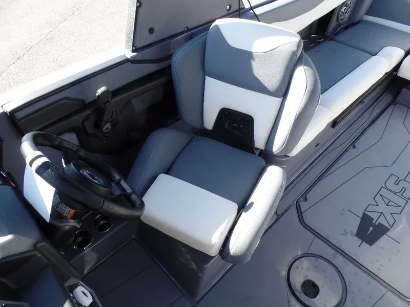 Slide: The Image of 2023 Axis T235 boat interior with gray and white seating, steering wheel, and cup holders. - 8