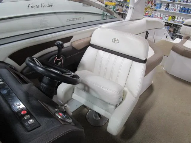Slide: The Image of 2014 Cobalt 26 SD boat interior with steering wheel and captain's seat. - 10