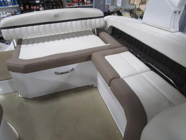 Slide: The Image of 2014 Cobalt 26 SD boat interior with white and brown seating. - 12