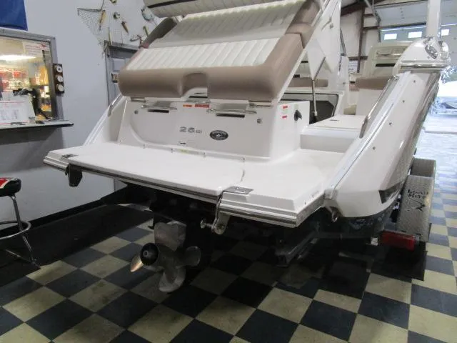 Slide: The Image of 2014 Cobalt 26 SD boat in garage, rear view with propeller and swim platform. - 19