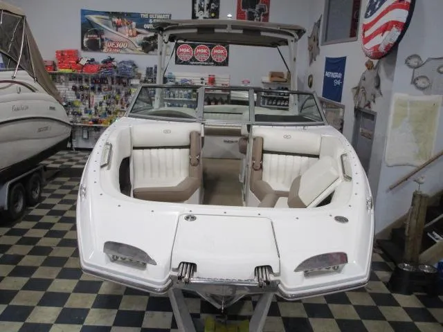 Slide: The Image of 2014 Cobalt 26 SD boat displayed indoors with seating and accessories. - 2