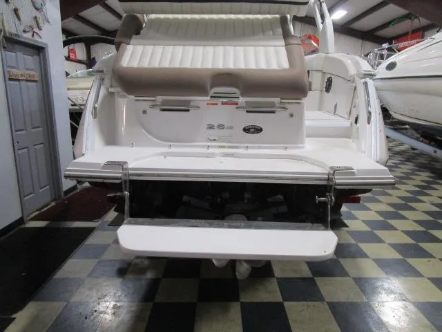 Slide: The Image of 2014 Cobalt 26 SD boat rear view in showroom with checkered floor. - 20