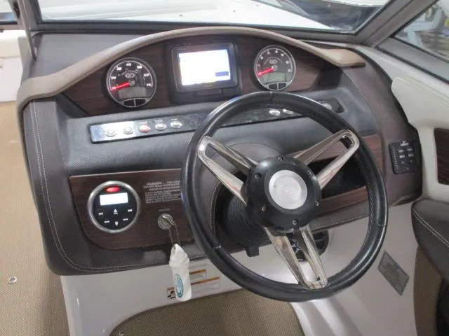 Slide: The Image of 2014 Cobalt 26 SD boat dashboard with steering wheel and gauges. - 6