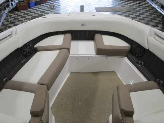 Slide: The Image of 2014 Cobalt 26 SD boat interior with beige seating and spacious layout. - 7