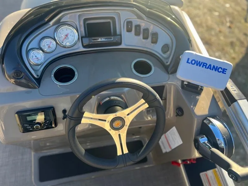 Slide: The Image of 2023 Sun Tracker FISHIN' BARGE® 20 DLX dashboard with Lowrance fishfinder and steering wheel. - 6