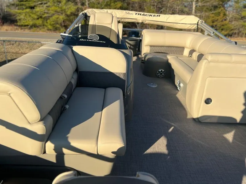 Slide: The Image of 2023 Sun Tracker FISHIN' BARGE® 20 DLX interior with beige seating. - 7