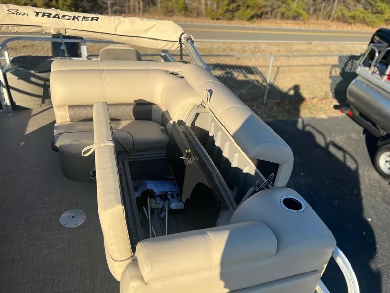 Slide: The Image of 2023 Sun Tracker FISHIN' BARGE® 20 DLX with beige seating and storage compartments. - 8