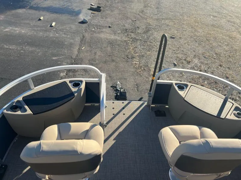 Slide: The Image of 2023 Sun Tracker FISHIN' BARGE® 20 DLX boat interior with two beige seats. - 9