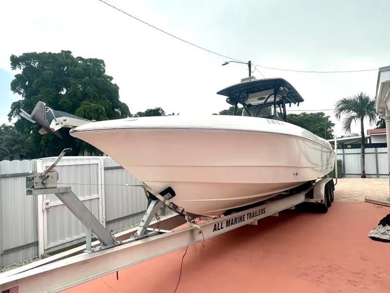 Slide: The Image of 2006 Wellcraft 310 CC boat on trailer in driveway. - 0