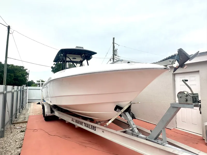 Slide: The Image of 2006 Wellcraft 310 CC boat on trailer in driveway. - 1